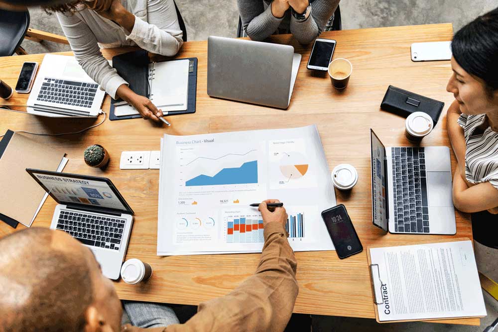 coworkers designing business strategy on desk